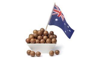 Bowl with macadamia nuts and the australian flag on white background