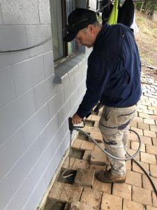 Graham applying termite chemical treatment for pest control